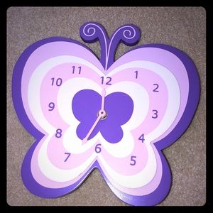 A purple, pink and white butterfly clock.
